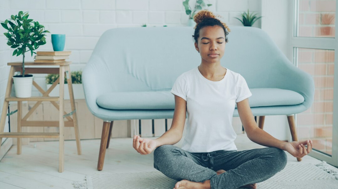 person meditating in quiet room