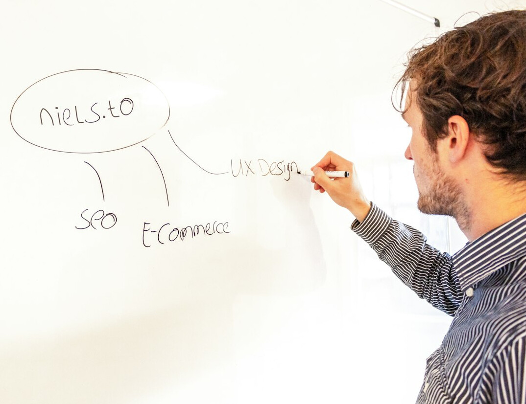 man explaining concept on whiteboard
